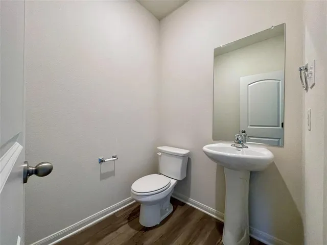a bathroom with a sink toilet and a mirror