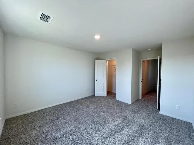 an empty room with closet area