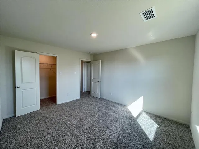 a view of an empty room and a window