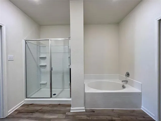a bathroom with a bathtub and shower
