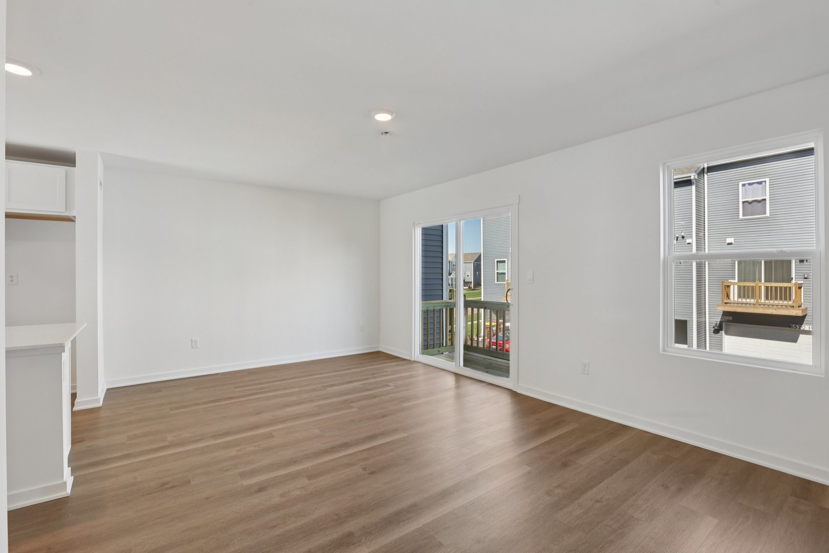 1403 Oakfield Lane Pingree Grove, IL 60140 - Photo 12 of 48 a view of an empty room with wooden floor and a window