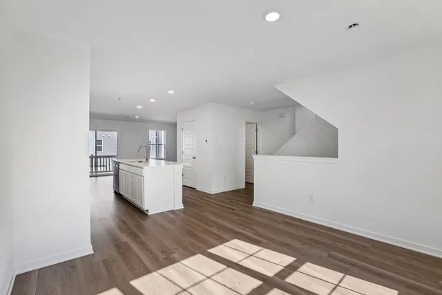 a view of kitchen and hall with wooden floor