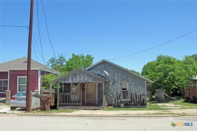 a view of a house next to a yard