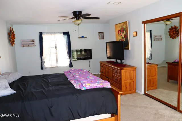 a bathroom with a granite countertop sink and mirror