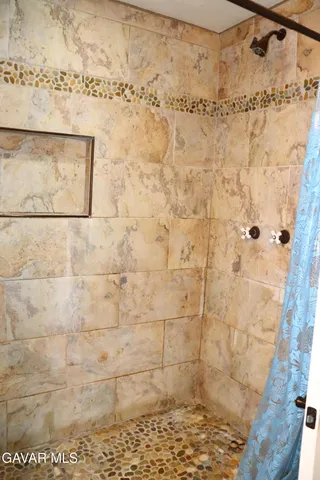 a view of a bedroom with wooden floor and stairs