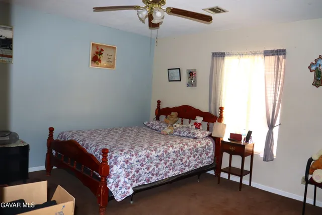 a bedroom with a bed and cabinets