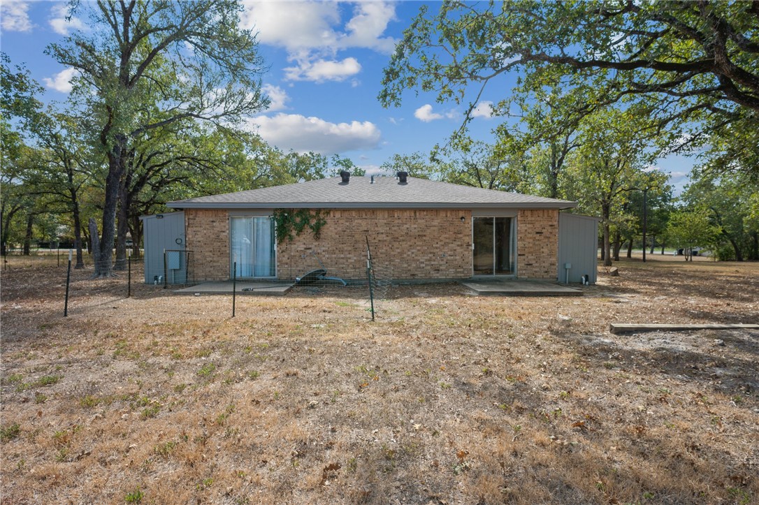 4950 Schehin Road College Station, TX 77845 - Photo 12 of 13 a house with trees in front of it