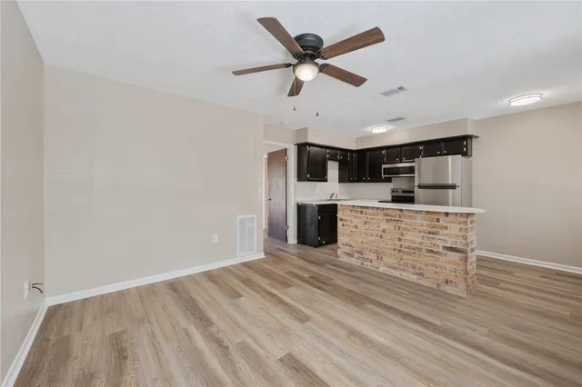 a view of kitchen with cabinets and wooden floor