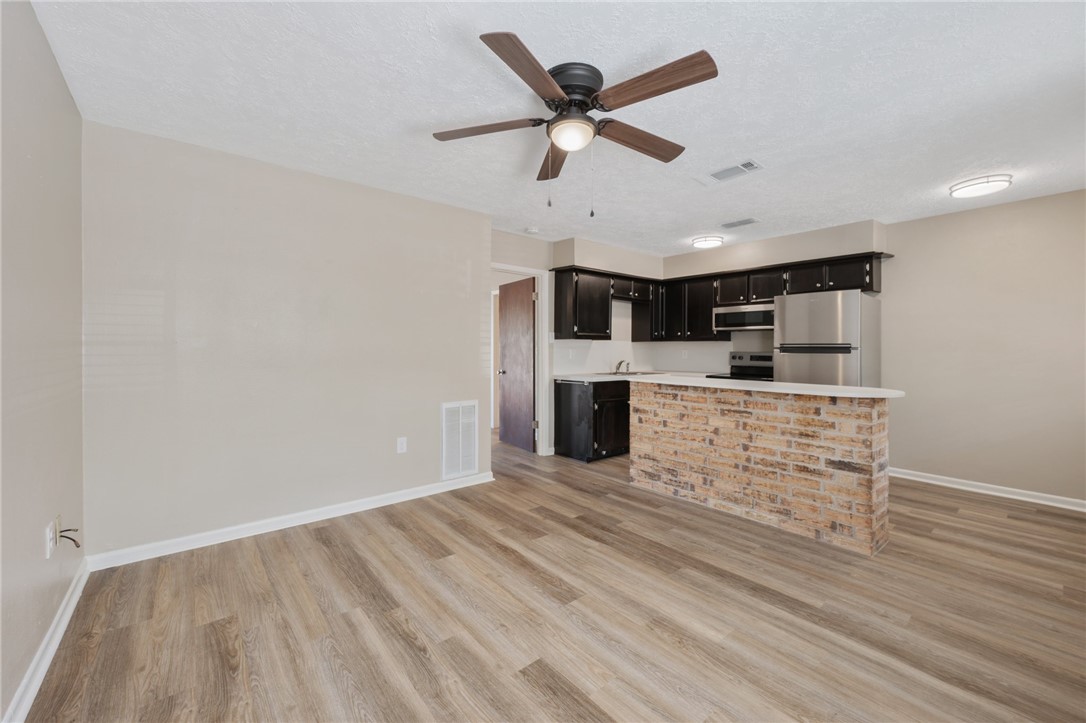 4950 Schehin Road College Station, TX 77845 - Photo 3 of 13 a view of kitchen with cabinets and wooden floor