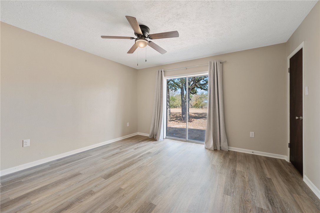 4950 Schehin Road College Station, TX 77845 - Photo 7 of 13 wooden floor in an empty room with a window
