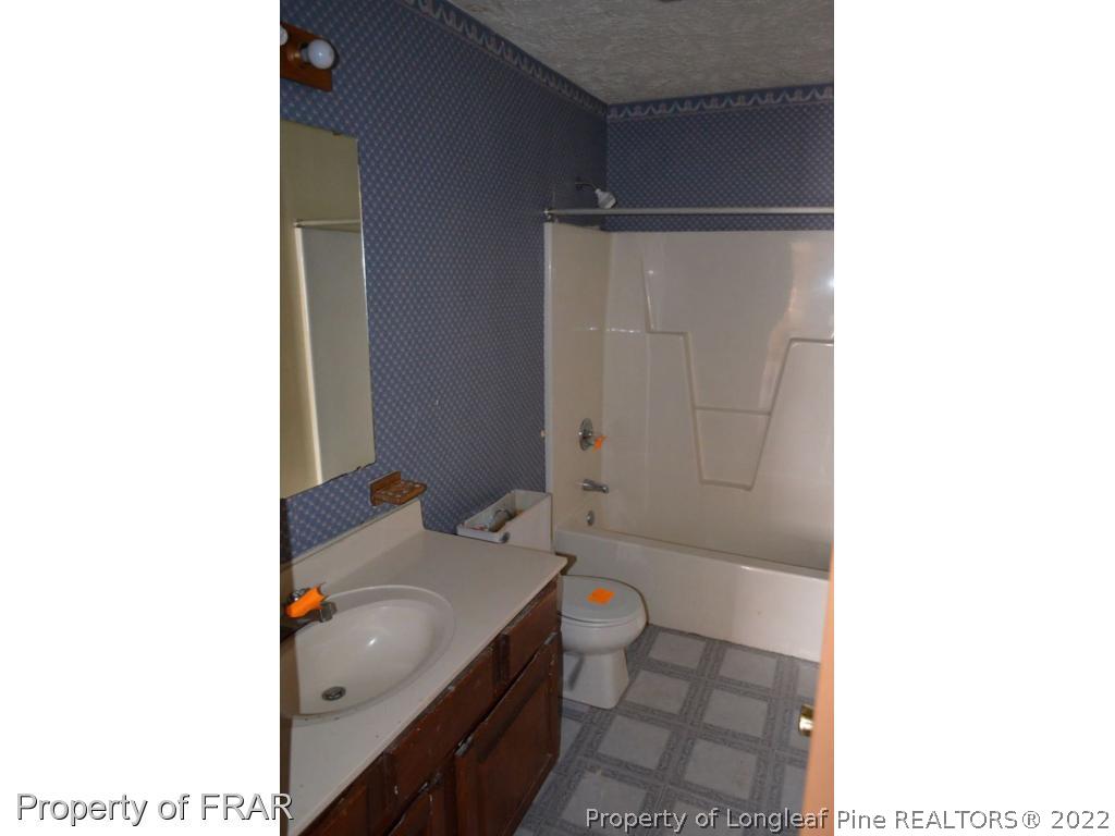 110 Bruce Lane Spring Lake, NC 28390 - Photo 17 of 21 a bathroom with a sink toilet and shower