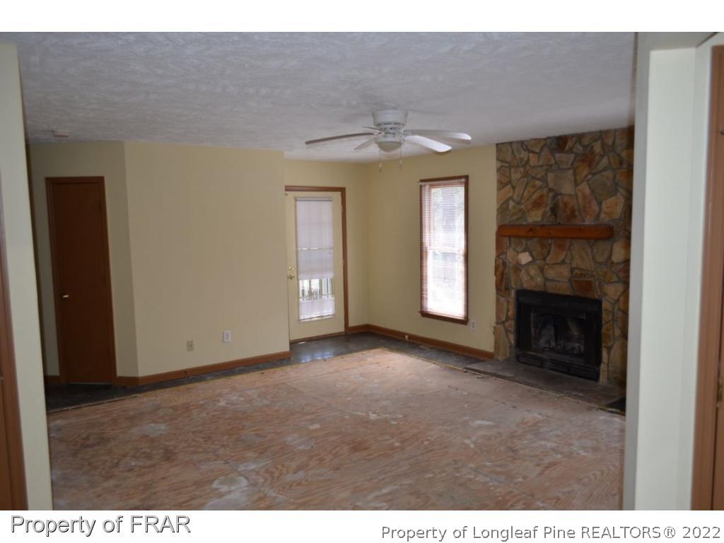 110 Bruce Lane Spring Lake, NC 28390 - Photo 5 of 21 a view of an empty room with a fireplace and a window