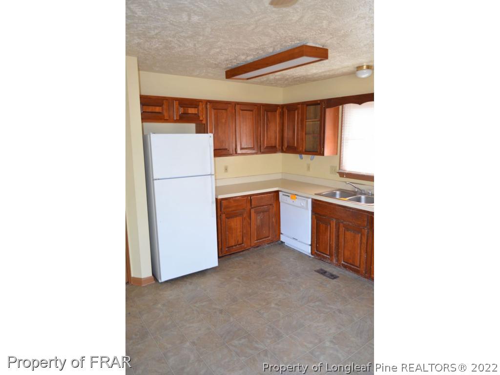 110 Bruce Lane Spring Lake, NC 28390 - Photo 8 of 21 a kitchen with stainless steel appliances a refrigerator and a more cabinets