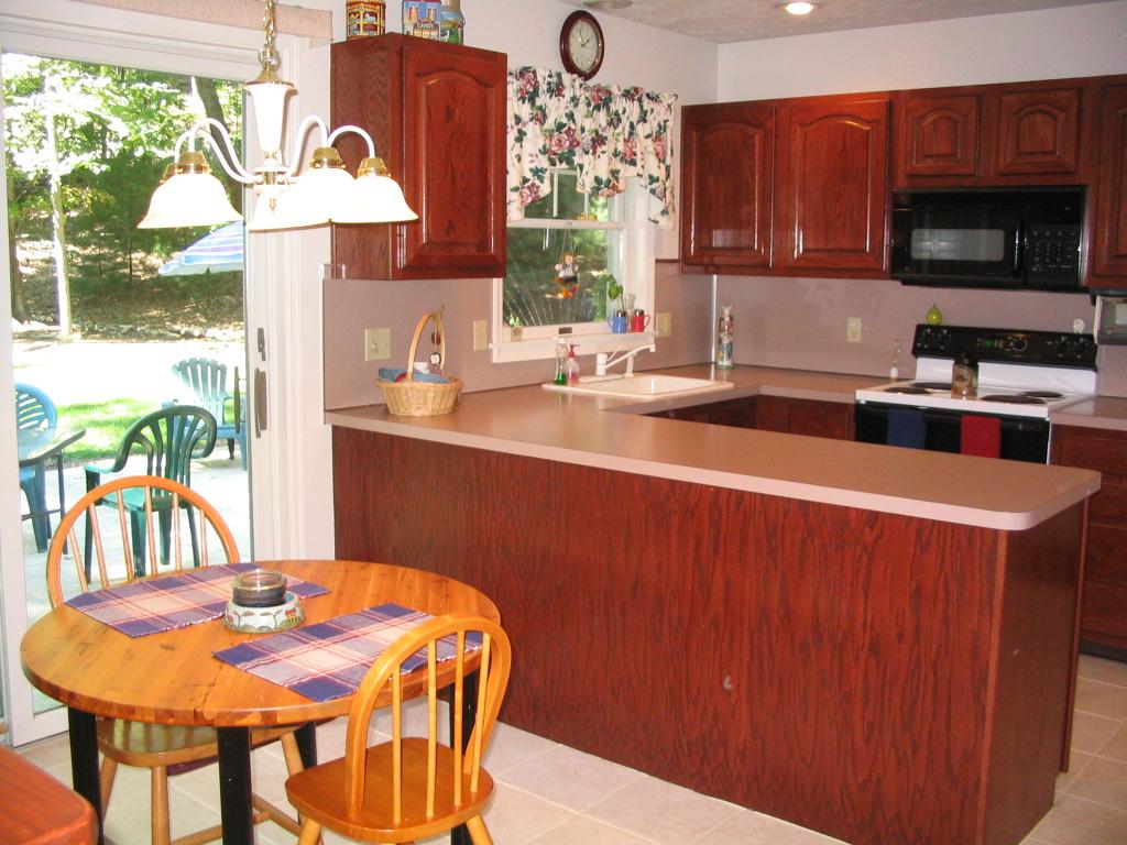 106 Kelly Road Stroudsburg, PA 18360 - Photo 8 of 18 a kitchen with stainless steel appliances wooden cabinets a stove a sink and a microwave