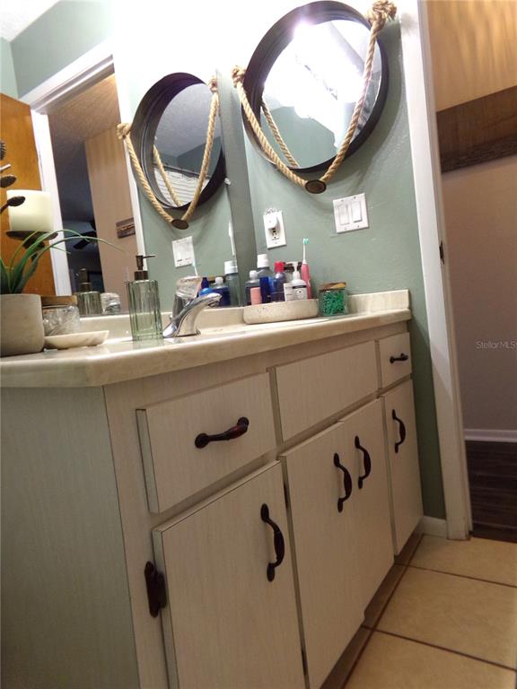 33068 Round Table Road Dade City, FL 33523 - Photo 44 of 82 a bathroom with a mirror and sink