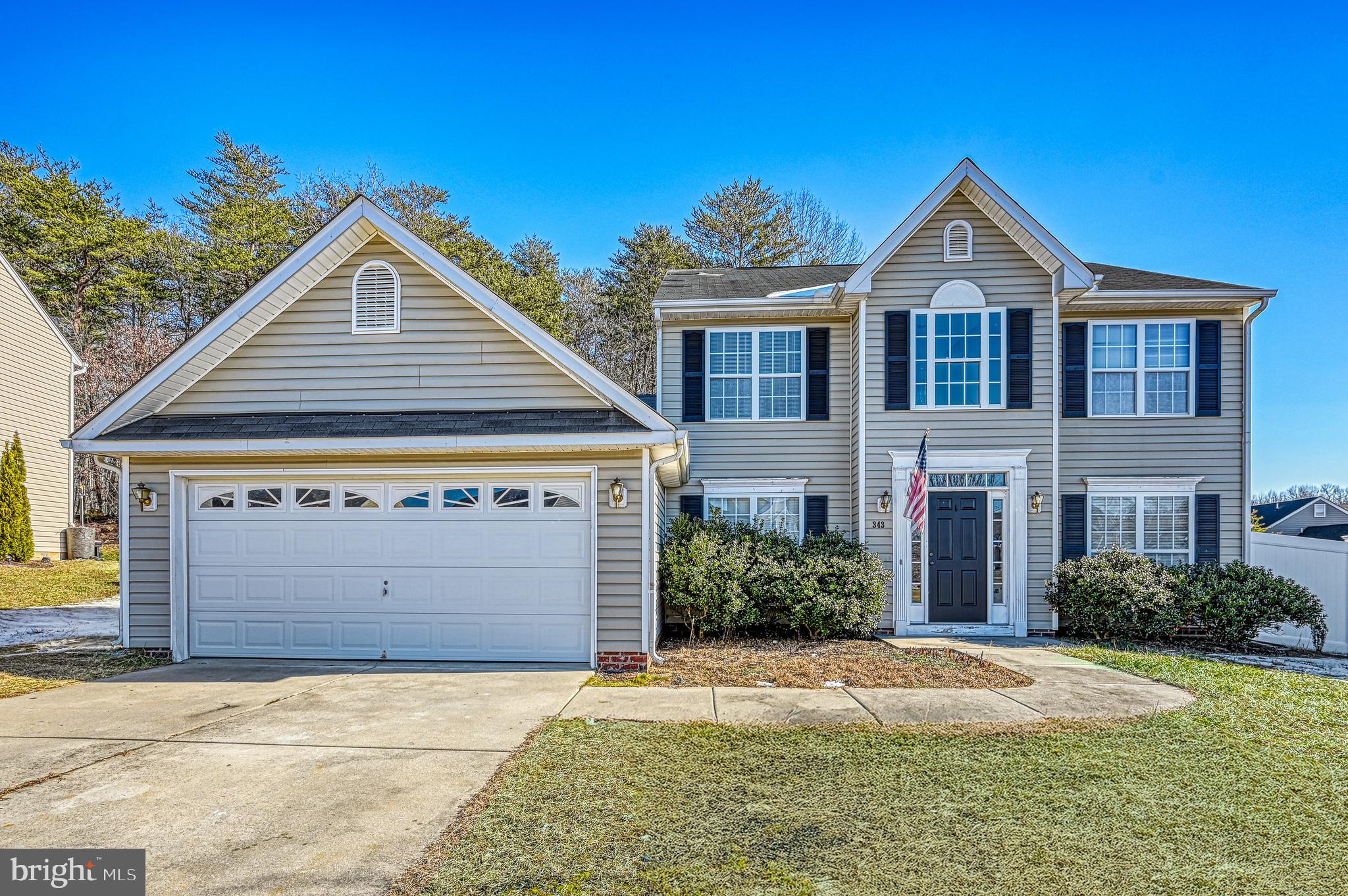 343 Cardinal Road Louisa, VA 23093 - Photo 1 of 48 a front view of a house with a yard and garage