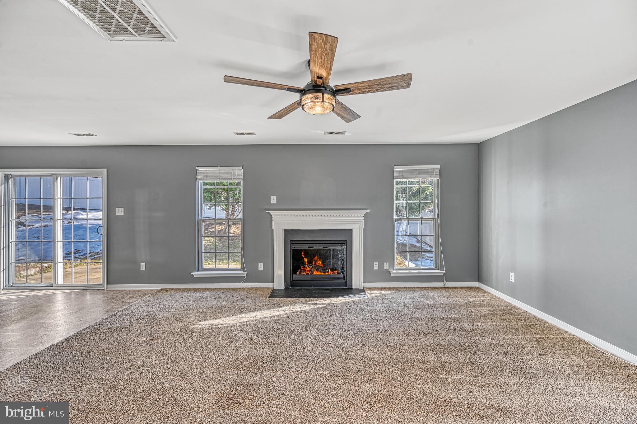 343 Cardinal Road Louisa, VA 23093 - Photo 12 of 48 an empty room with fireplace and windows