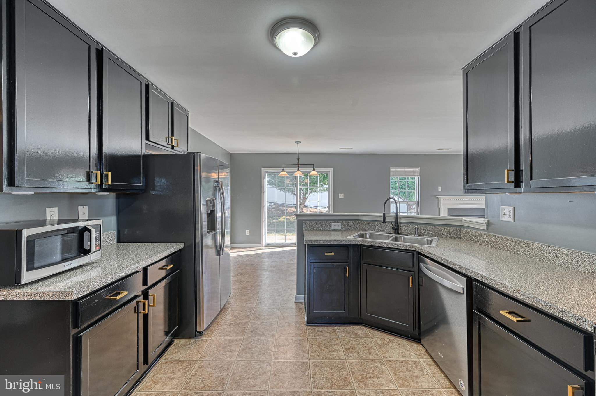 343 Cardinal Road Louisa, VA 23093 - Photo 17 of 48 a kitchen with stainless steel appliances granite countertop a sink a stove and refrigerator