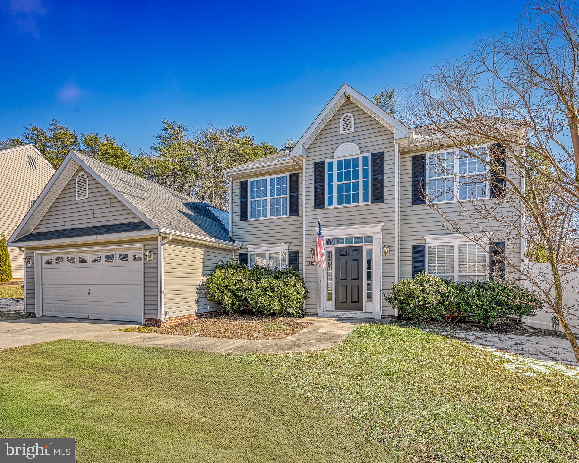 343 Cardinal Road Louisa, VA 23093 - Photo 2 of 48 a front view of a house with a garden
