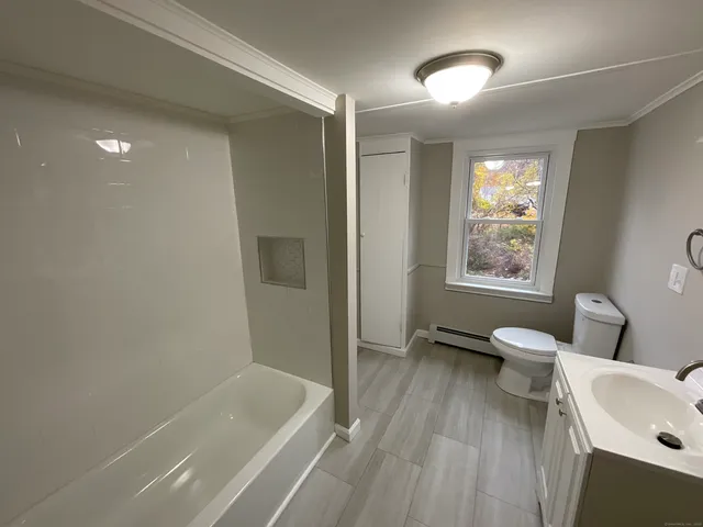a bathroom with a sink a toilet and a bathtub