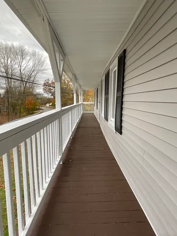 a view of a balcony with wooden floor
