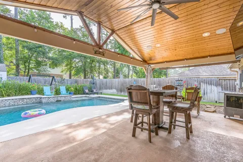 a view of a patio with a table and chairs