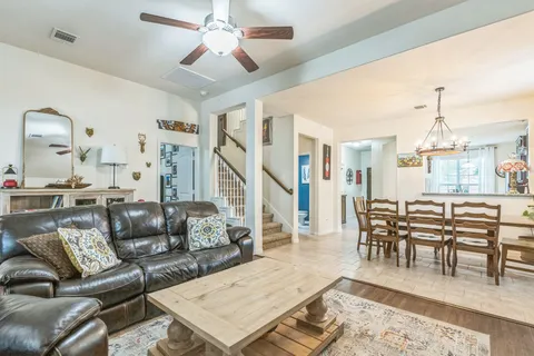a living room with furniture a rug and white walls