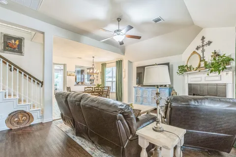 a living room with furniture a fireplace and a table