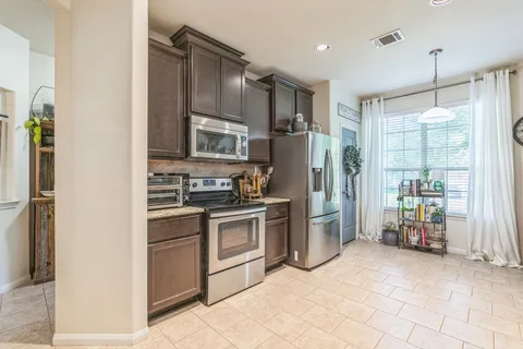 a kitchen with a refrigerator sink and stove