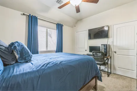 a bedroom with a bed and a television