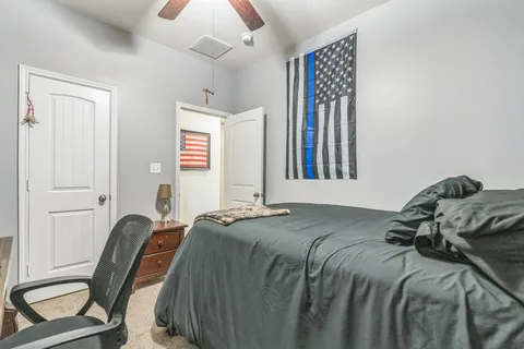 a bed sitting in a bedroom next to a window