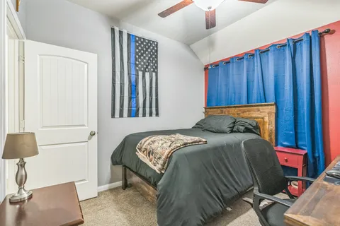 a bedroom with a bed and a lamp