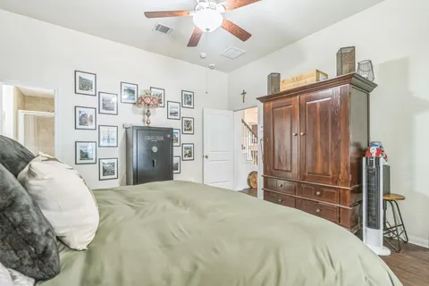 a bedroom with a large bed and a chandelier