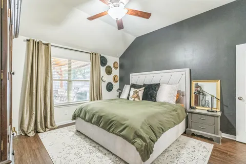 a bedroom with a large bed and a chandelier