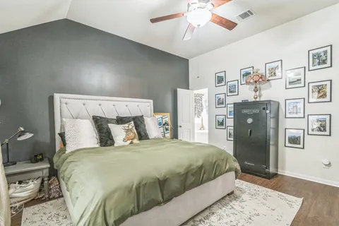 a bedroom with a large bed and a chandelier