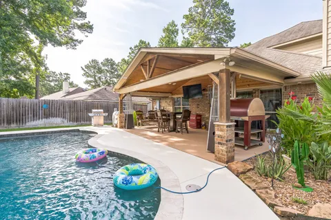 a view of a patio with table and chairs potted plants