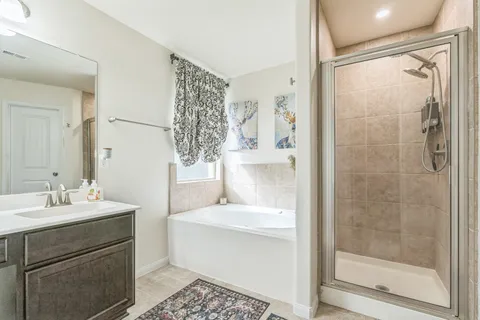 a bathroom with a shower sink and mirror