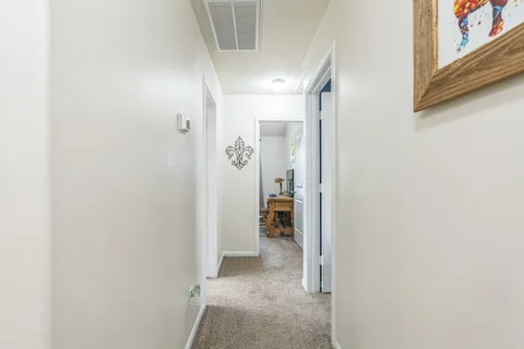a view of a hallway with wooden shelves