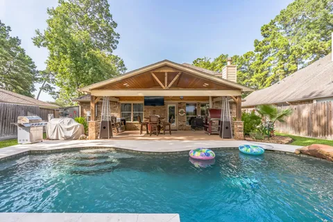 a front view of a house with swimming pool having outdoor seating
