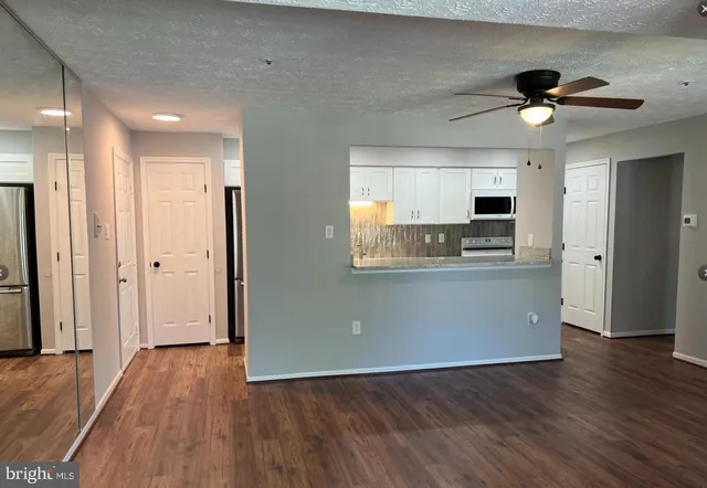a view of kitchen with granite countertop cabinets and wooden floor