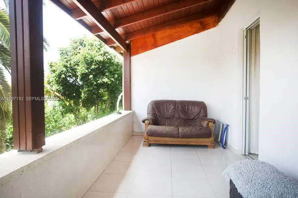 a view of a porch with chairs and backyard