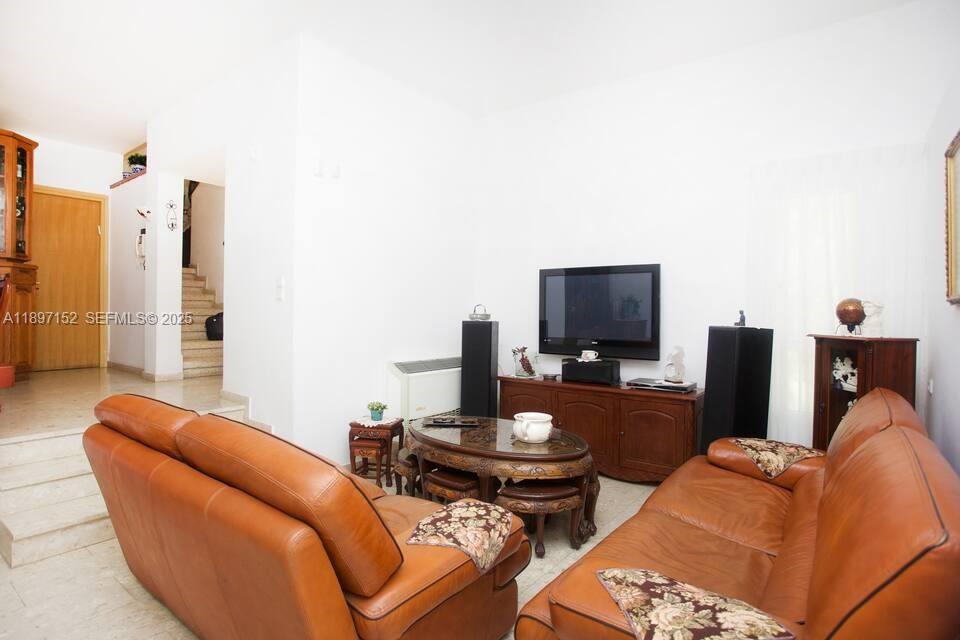 10 Hapiyyus Fort Wayne, IL 46814 - Photo 8 of 31 a living room with furniture and a flat screen tv