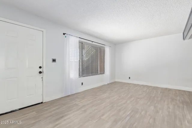 a view of a room with wooden floor and windows