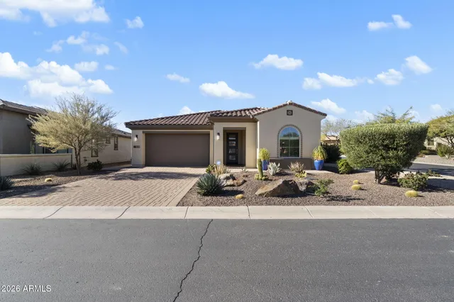 a front view of a house with yard and outdoor seating