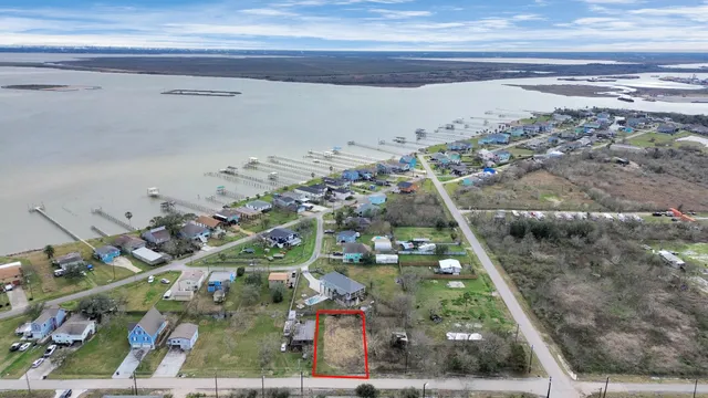 an aerial view of a houses with a yard