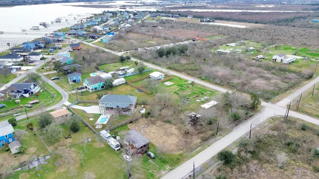 an aerial view of a house with a yard and large trees
