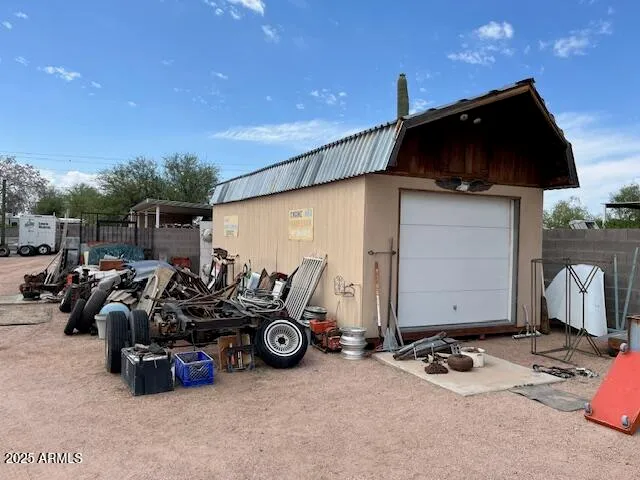 a view of a patio with table and chairs and a barbeque
