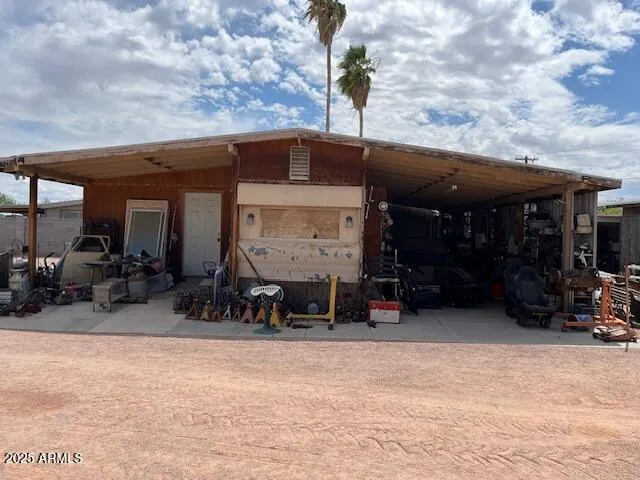 a view of a house with yard and sitting area
