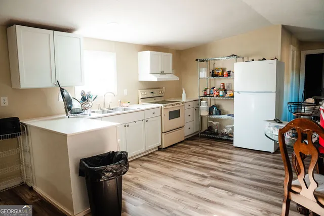 a kitchen with a sink appliances and cabinets