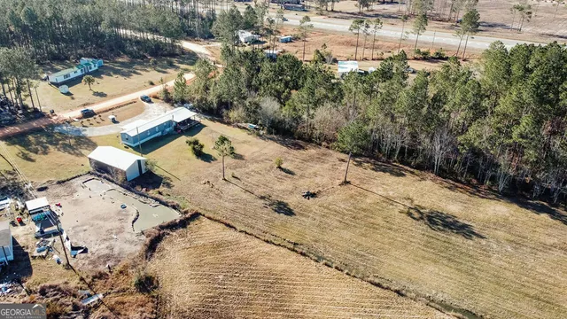 an aerial view of a house with a yard